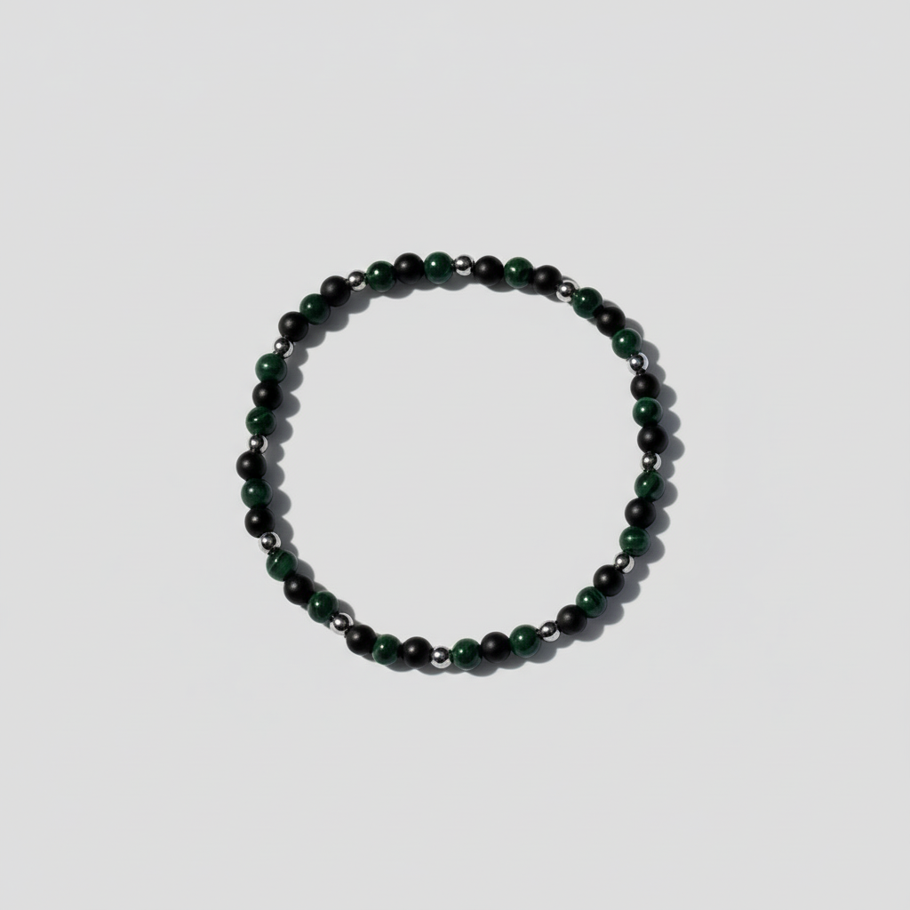Black and green crystals bracelet on a light fabric background